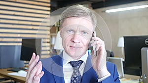 Portrait of overworked sad businessman holding phone and yelling