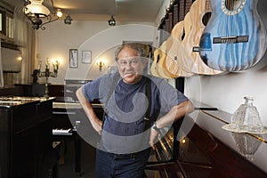 Portrait Of Owner Leaning In Music Store