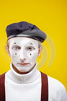 Portrait of a pantomime on the yellow background