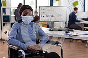 Portrait of paralyzed african american businesswoman in wheelchair