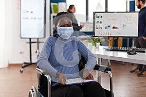 Portrait of paralyzed african american businesswoman in wheelchair