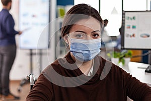 Portrait of paralyzed businesswoman wearing protective face mask