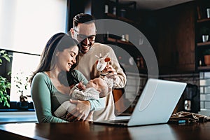 Portrait of parents and newborn baby. Father and mother kiss and hug a beautiful newborn child. .