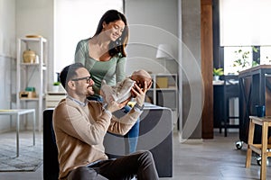 Portrait of parents and newborn baby. Father and mother kiss and hug a beautiful newborn child. .