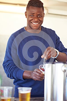 Portrait, party and a black man bartender serving drinks outdoor at an event, festival or celebration. Smile, beer and