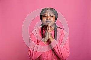 Portrait of peaceful african american model praying to god asking for forgiveness