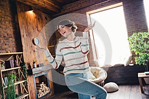 Portrait of peaceful carefree positive girl have good mood dance rejoice sunlight window house indoors