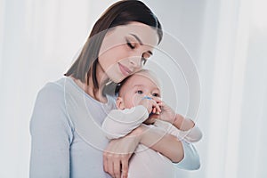 Portrait of peaceful girl closed eyes hands hold hug adorable kid enjoy free time weekend indoors