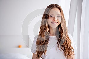 Portrait of peaceful nice girl toothy smile enjoy spend free time weekend spacious bedroom flat inside