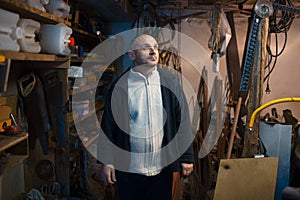 Portrait of pensive adult man in his workshop room