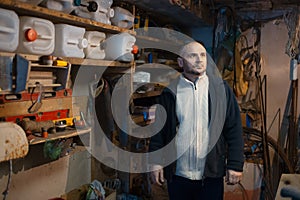 Portrait of pensive adult man in his workshop room