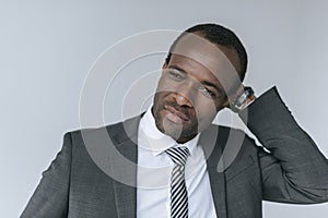 portrait of pensive african american businessman in suit looking away