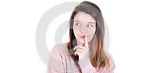 Portrait of a pensive brunette young woman standing looking side