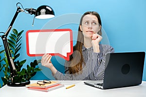 Portrait of pensive employee young business female sit work at white office desk with laptop empty blank Say cloud speech bubble