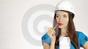 Portrait of pensive female construction engineer or architect in hard hat