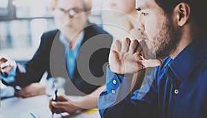 Portrait of pensive hispanic businessman on the business meeting with partners in modern office.Horizontal,blurred