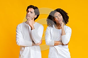 Portrait of pensive interracial couple thinking about something and looking away photo