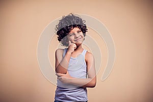 A portrait of pensive kid boy. Children and emotions concept