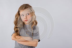 Portrait of pensive little girl isolated on a white background