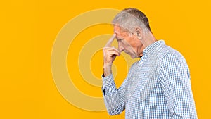 Portrait of pensive mature man looking aside at studio