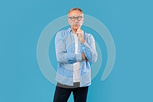 Portrait of pensive mature man looking at camera