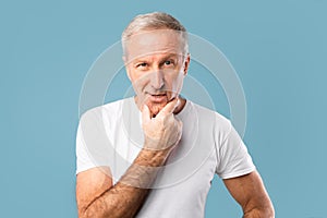 Portrait of pensive mature man looking at camera