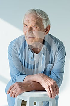 Portrait of pensive senior man in stylish shirt