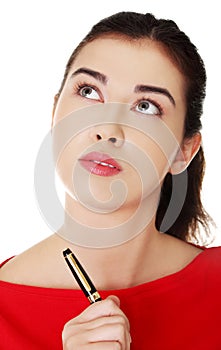 Portrait of a pensive student woman holding pen