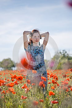 Portrait of pensive woman on poppy field