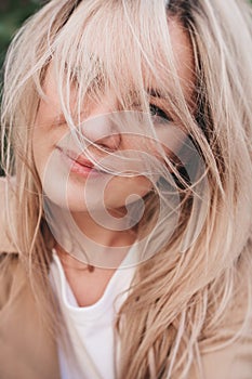 Portrait of a pensive young girl with blond hair.