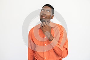 Portrait of pensive young man rubbing chin