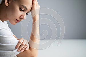 Portrait of pensive young woman with short hair on white background. Copy space