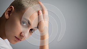 Portrait of pensive young woman with short hair on white background. Copy space