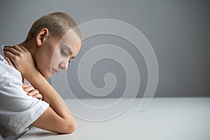 Portrait of pensive young woman with short hair on white background. Copy space