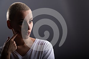 Portrait of pensive young woman with short hair on white background. Copy space
