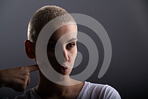 Portrait of pensive young woman with short hair on white background. Copy space