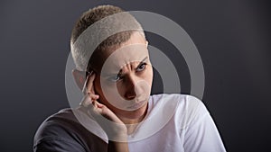 Portrait of pensive young woman with short hair on white background. Copy space