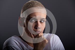 Portrait of pensive young woman with short hair on white background. Copy space