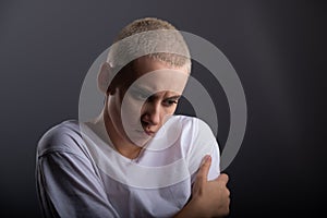 Portrait of pensive young woman with short hair on white background. Copy space