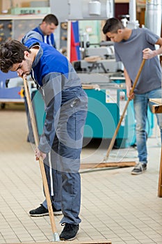 Portrait people cleaning factory floor