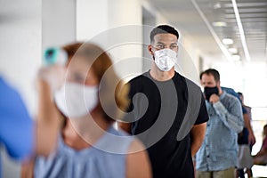 Portrait of people with face masks waiting, coronavirus, covid-19 and vaccination concept.