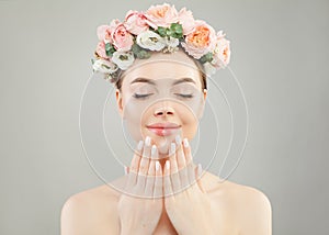 Portrait of perfect woman spa model with clear skin, manicured nails and flowers