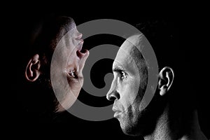 Portrait of a person the concept of two sides, psychological photography on a dark background.The man looks at his