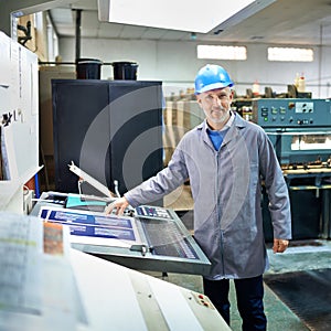 Portrait, person and printing in factory with paper, quality inspection and storage. Man, publishing plant and creative