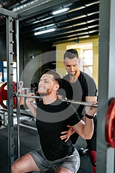 Portrait of personal trainer helping out and assisting clients in the gym. Fitness details of healthy life