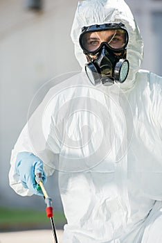 portrait of pest control worker in respirator looking