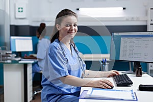 Portrait of pharmacist nurse typing medical prescription