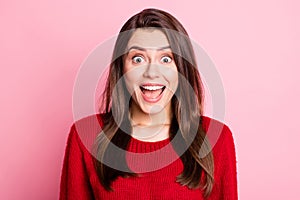 Portrait photo of amazed happy surprised brunette girl staring with opened mouth smiling wearing knitted sweater