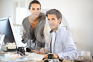 Portrait of photo reporters working at office photo