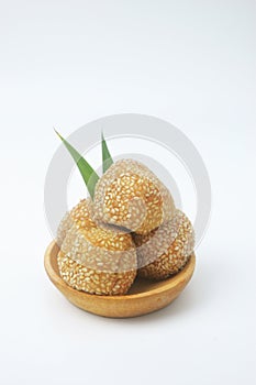 Portrait photo of a snack that has a golden round shape is often called Onde Onde photo